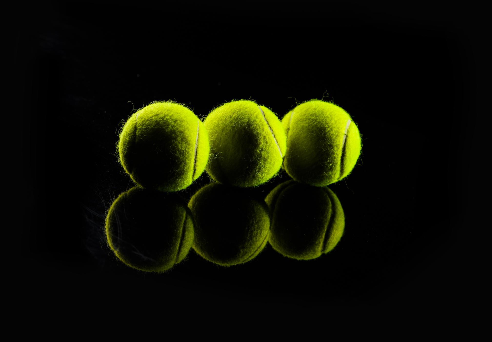 tennis-ball-isolated-black-with-dramatic-lighting-1